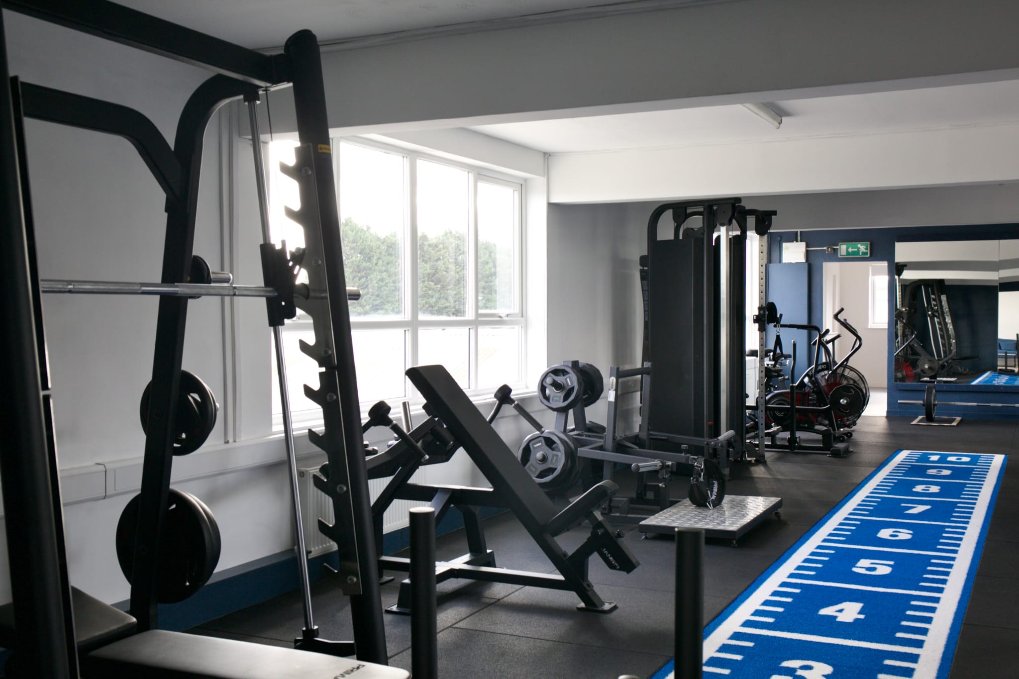 Strength equipment beside the Top Floor Performance training track